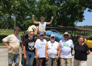 Ohio River Sweep participants and the pile of junk they collected from the river.