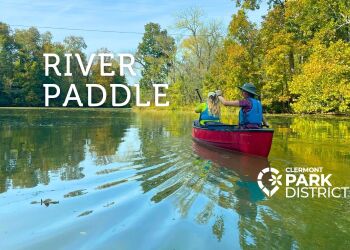 Two people in a red canoe on the river
