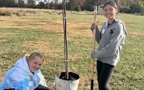 Girls planting tree